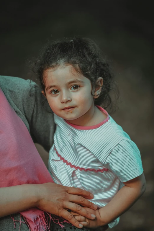 the young child is holding the woman's hand