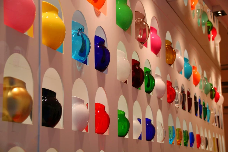 colorful circles mounted to the wall with a white structure and ceiling