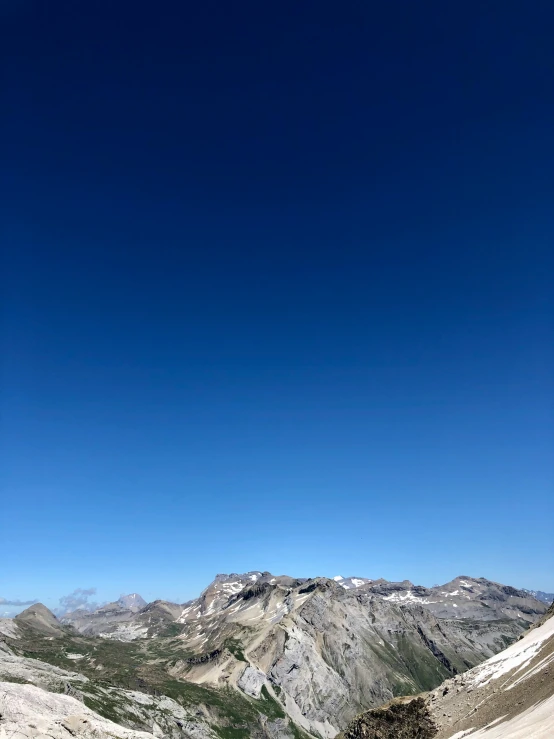 a person is standing on a skis looking up at mountains