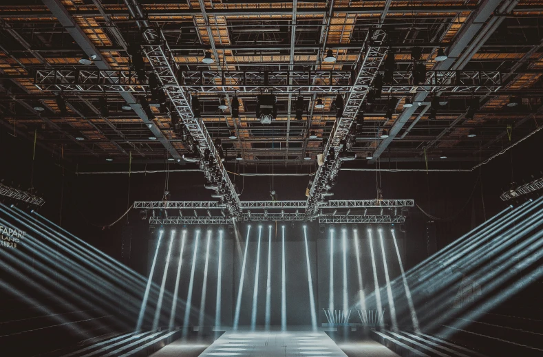 beams of light shine through the roof of a building