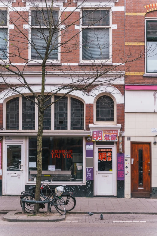 the bicycle is parked next to the bike shop