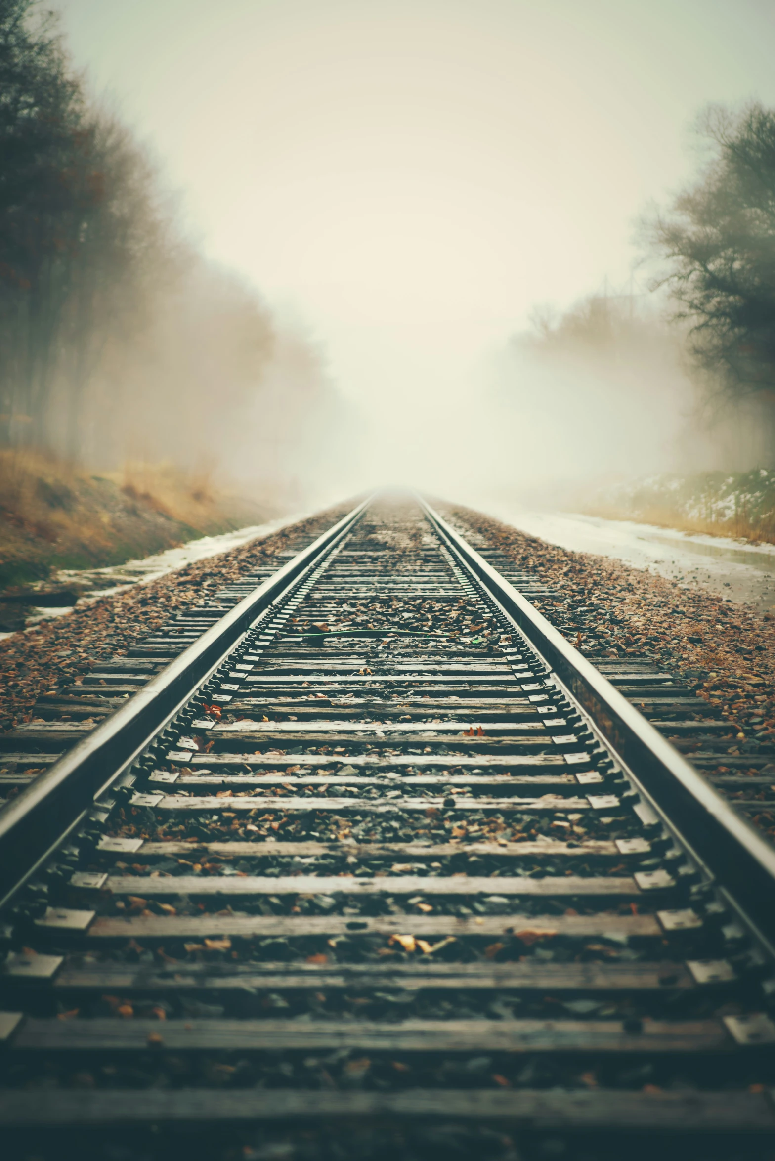 railroad tracks in the distance, with fog coming off the top