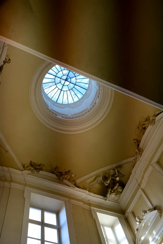 a ceiling with windows above it and a round skylight