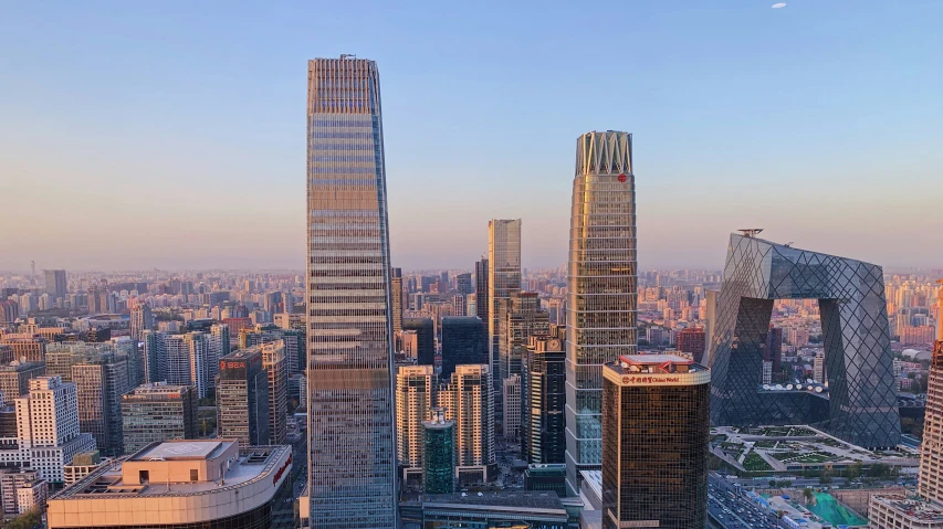 a city view of skyscrs in a downtown area at sunset