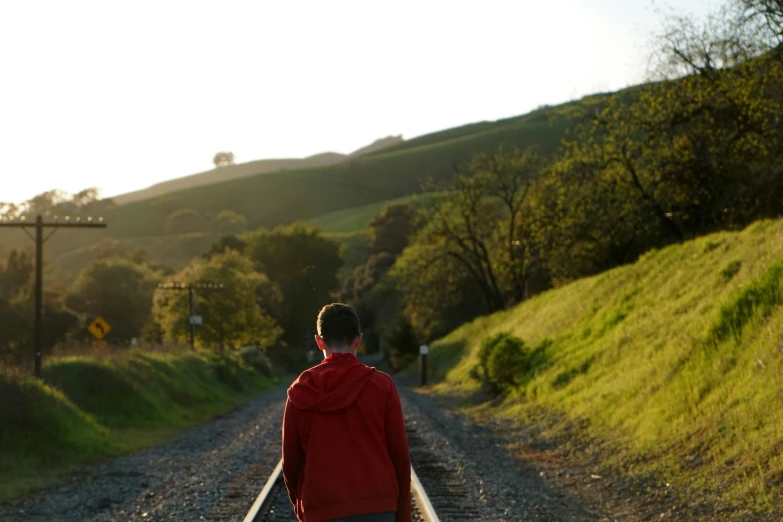 a person walking down the road with their suitcase