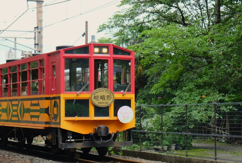 an old train with a few doors sits on the tracks