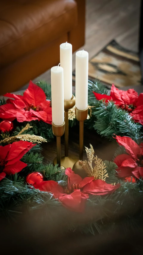 a christmas wreath with lit candles on top