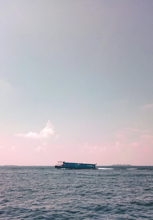 the ocean and sky is just beginning to clear as it floats