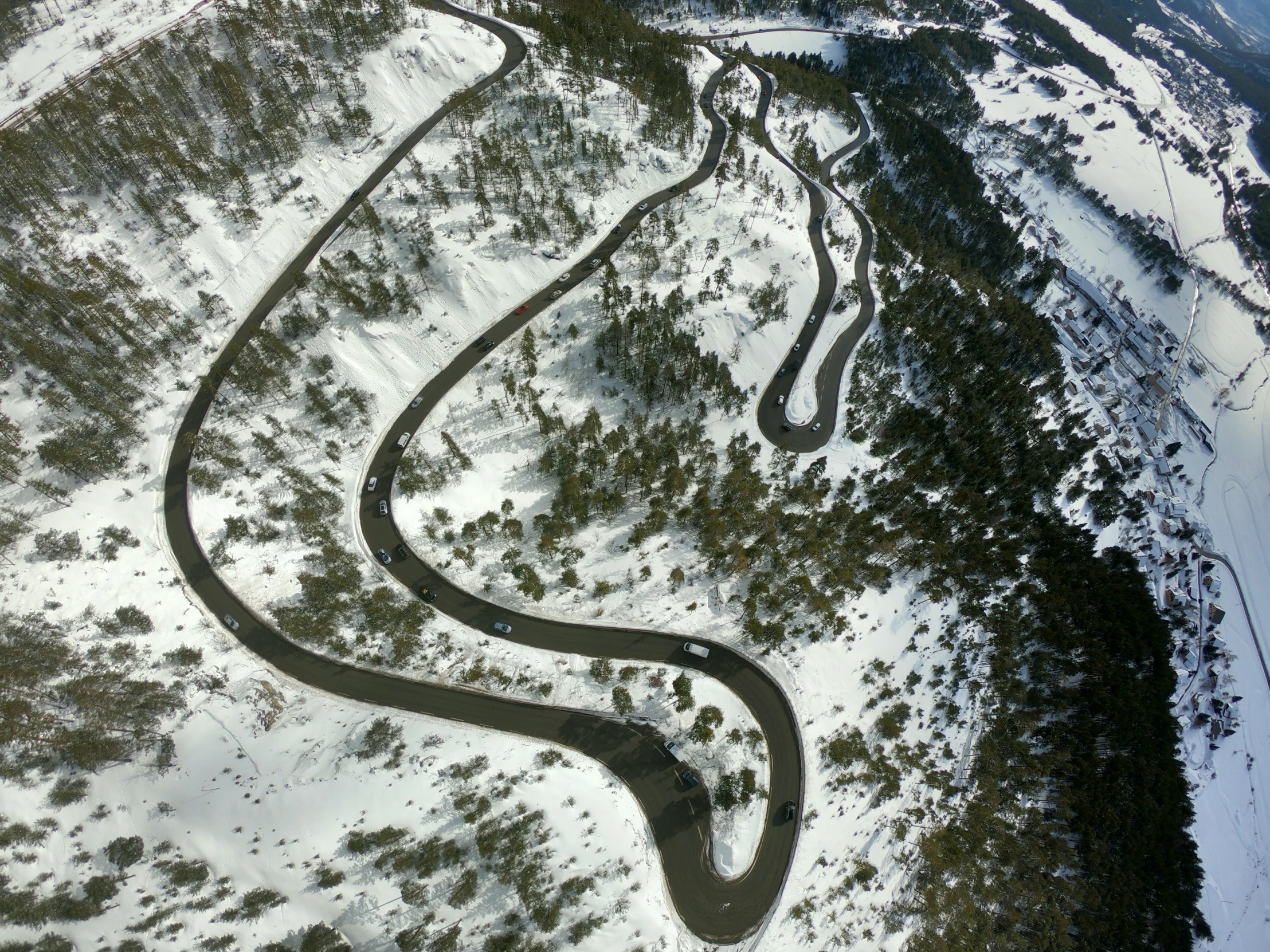 an aerial view of some winding roads in the snow