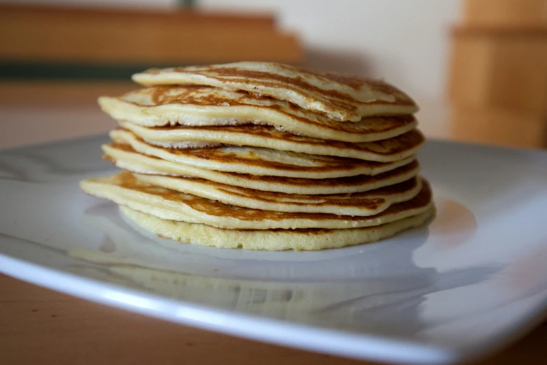 a stack of pancakes sitting on top of a white plate
