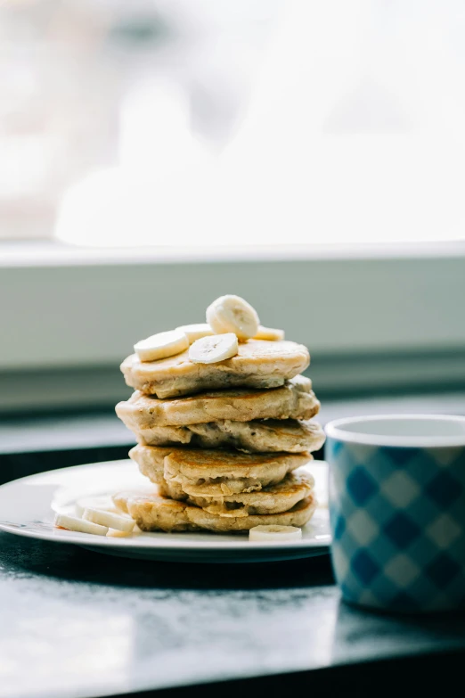 pancakes and coffee are sitting on a tray