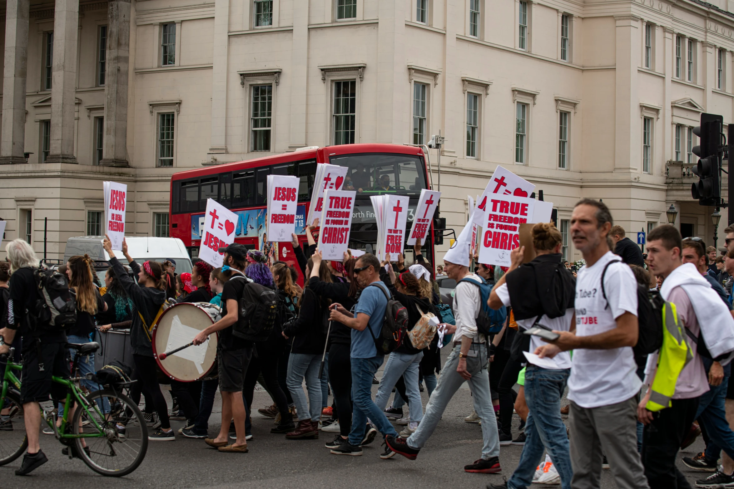 a group of people with signs walking down the street