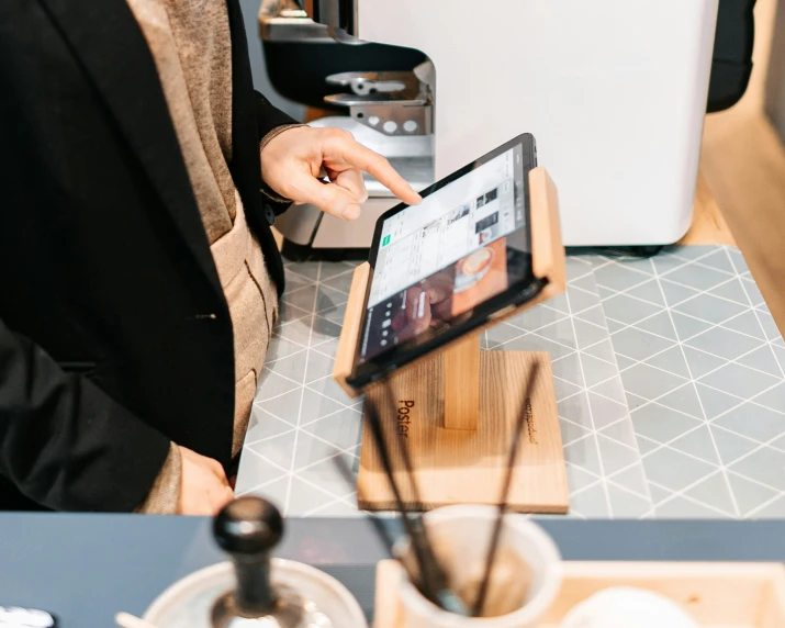 a person holding an ipad on a tray