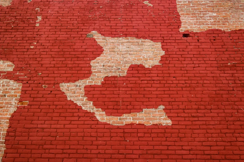 an old red brick wall has s in it