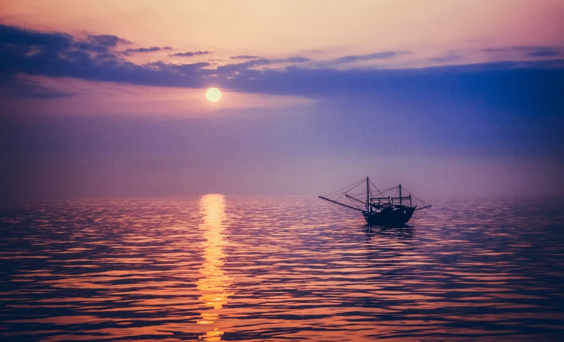 a boat floating on top of a large body of water