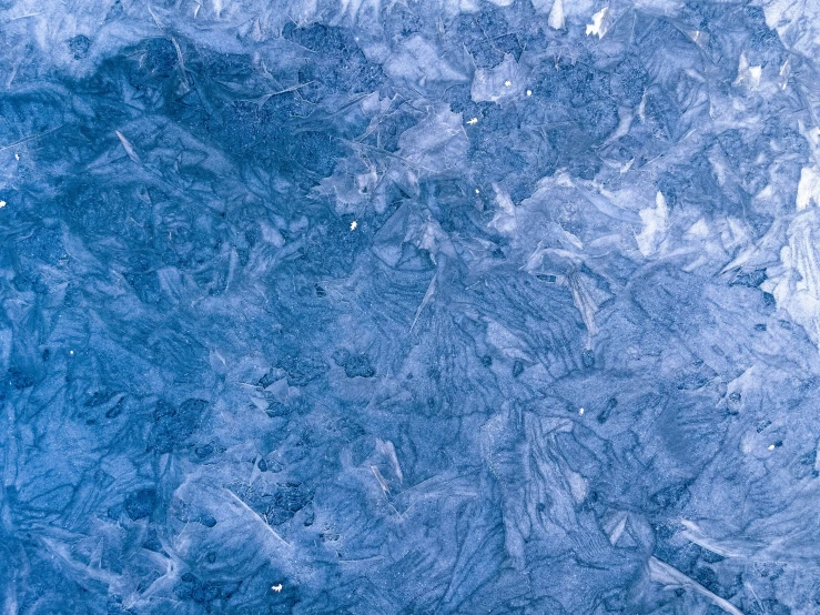 the bottom part of a blue, frosted rock that looks like ice