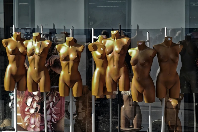 a couple of mannequins are standing out side of the window