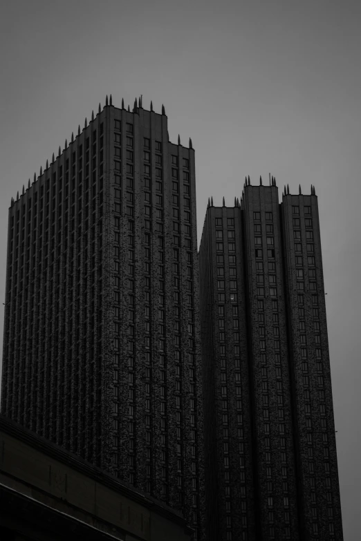 black and white po of three building, the sky is cloudy