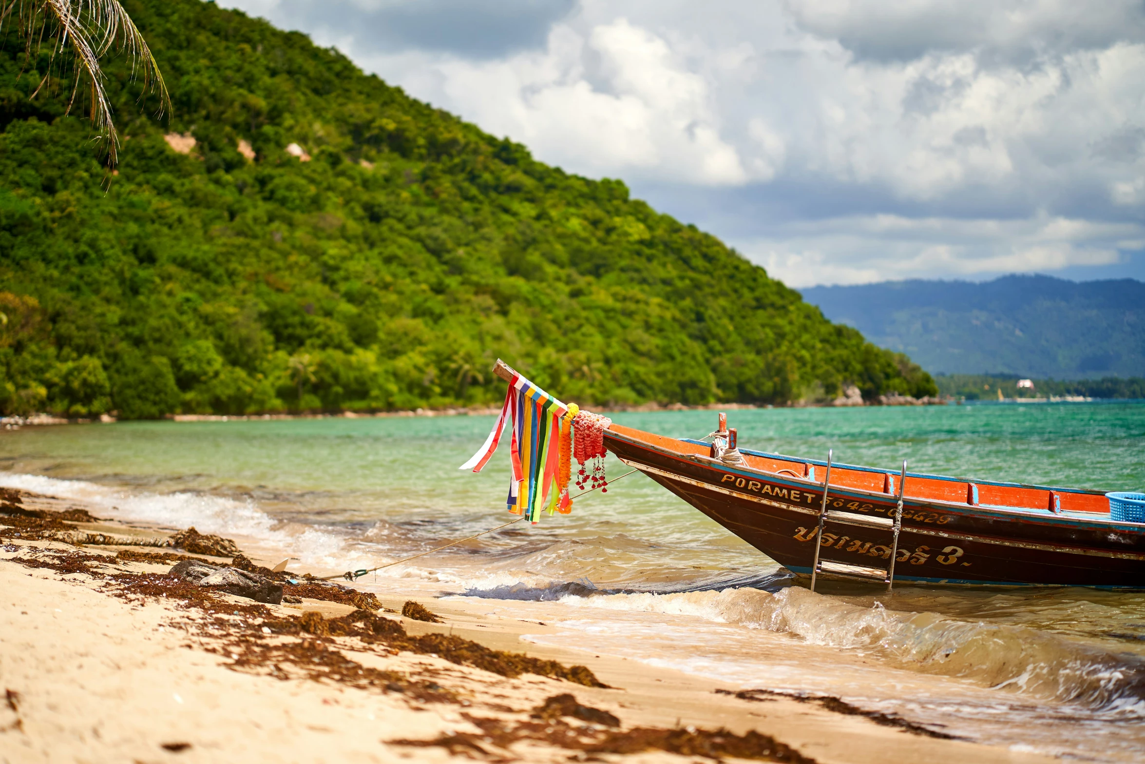 a boat that has been washed up onto the beach by the shore