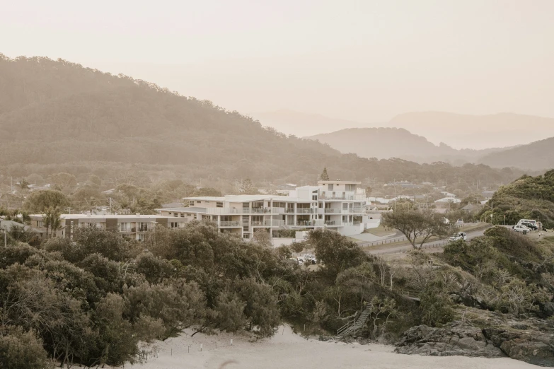 a house sits on a hill surrounded by trees