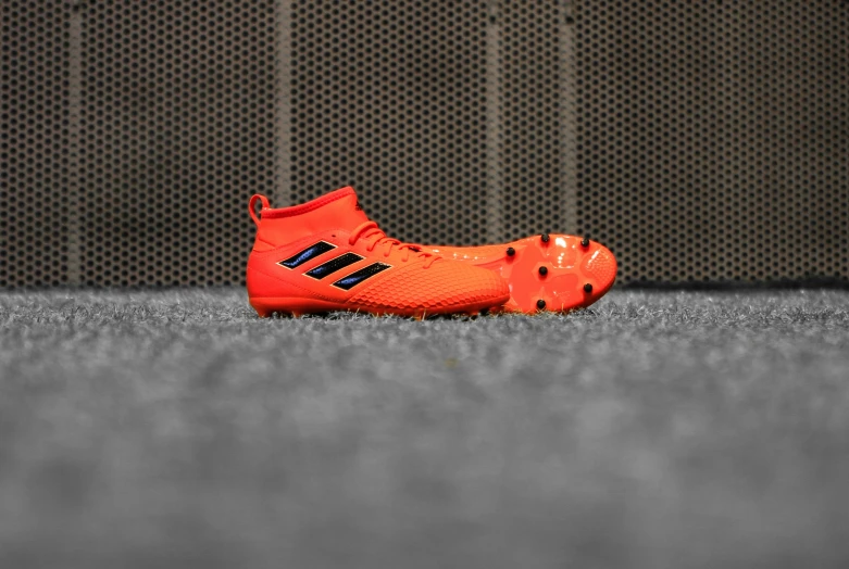 the soccer shoe is in the orange color