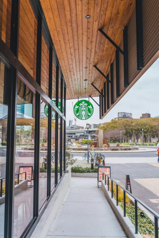 an empty sidewalk next to some stores on a rainy day