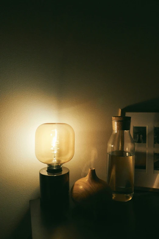 a light bulb is placed on the side of a table with two garlic and onion