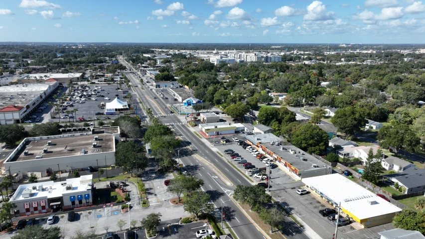 an aerial view of cars driving on the roadway in a city