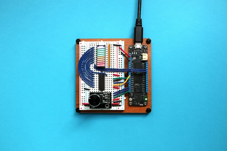 electronics on a white board with blue background