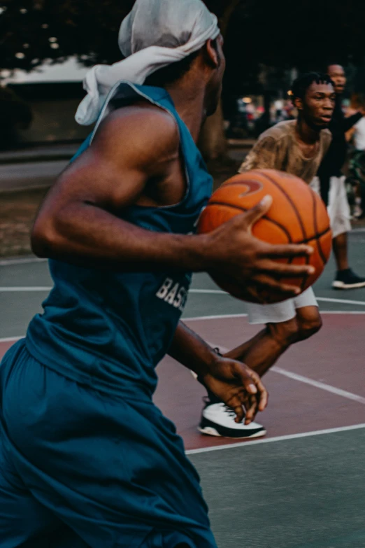 a man holding a basketball near other men