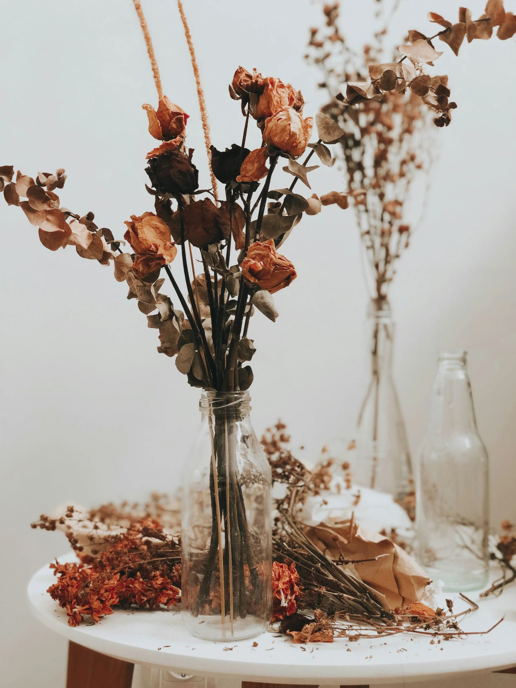 a vase full of dried flowers sitting on top of a table