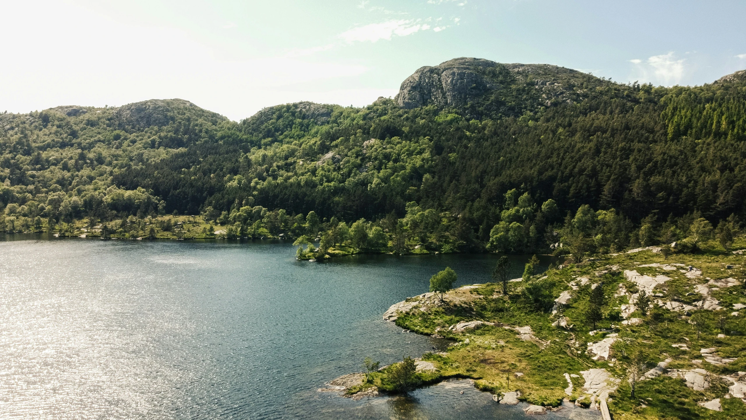 a river is surrounded by large boulders and mountains