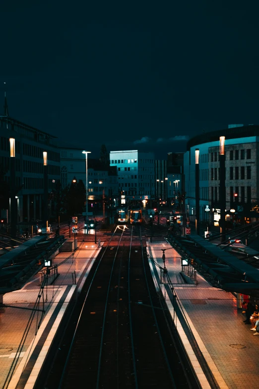 night time picture of two sets of tracks in an urban area