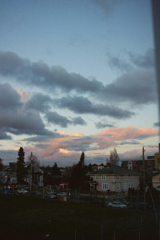 the view of a sunset and clouds through a window