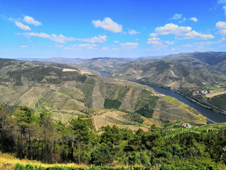 a valley and water in the middle of the mountain range