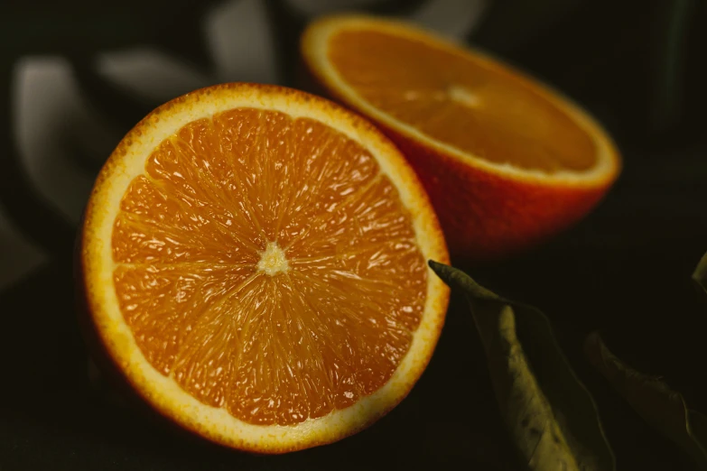 a sliced orange with a leaf on top