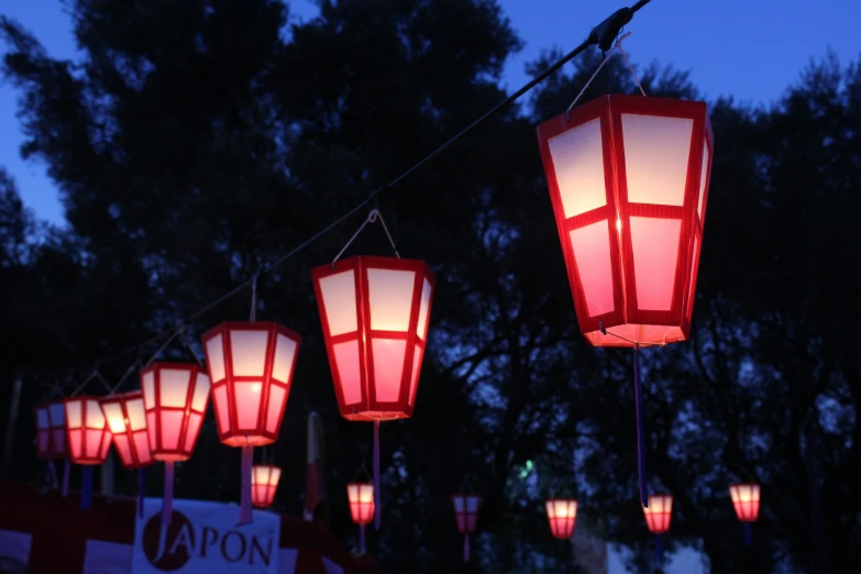 lamps hanging from a rope lit up with red lights