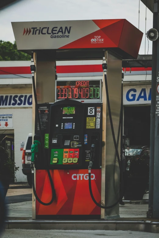 a gas station pump in front of a gas station