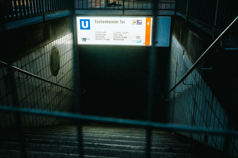 a metal and wood staircase with a sign that reads entering 101