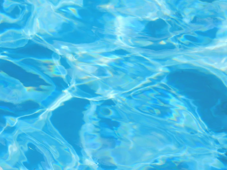 a clear blue water surface with some bubbles