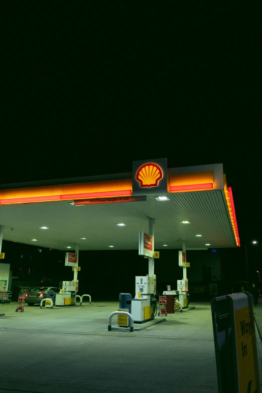 there is a shell gas station with a lit up sign