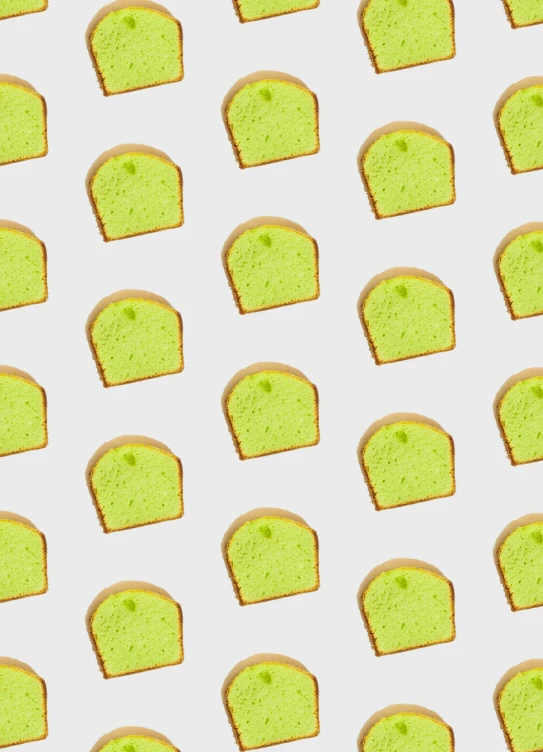 some slices of cake with green toppings sitting on a table