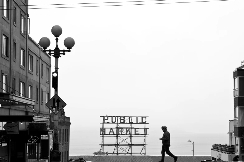 a person is walking down a city street with a sign in the foreground