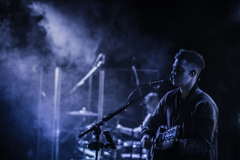 a man playing guitar at a concert