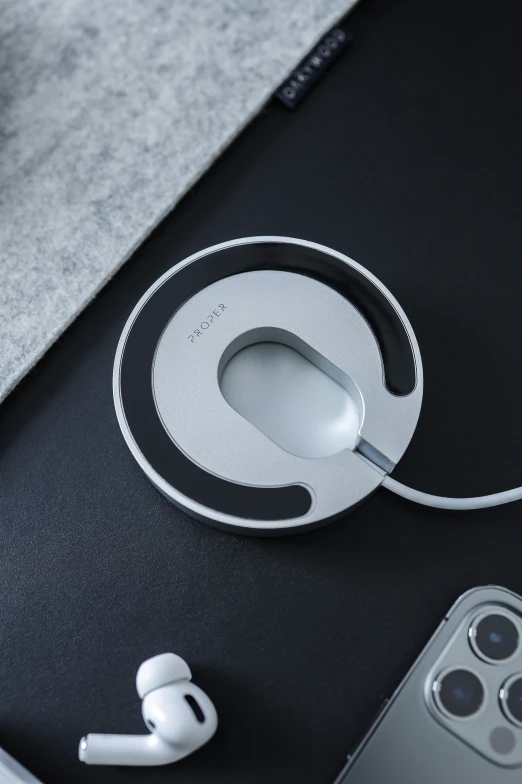 the wireless headphones are set up on the surface near a smart phone