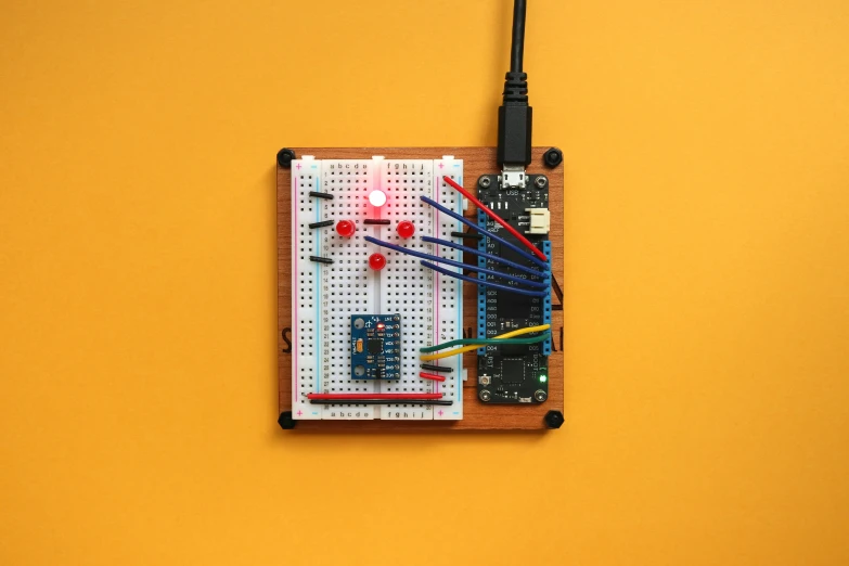 a raspberry board sits on top of a yellow surface