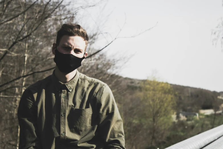 a man wearing a face mask looking forward