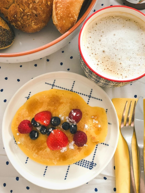 a breakfast plate topped with berries and other fruit