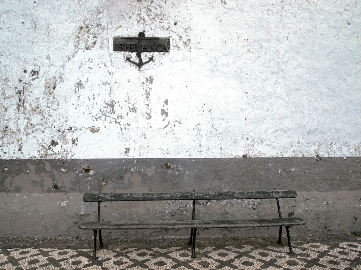 a bench on the side of the street under a light