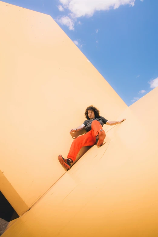 a girl in orange pants sitting on an airplane